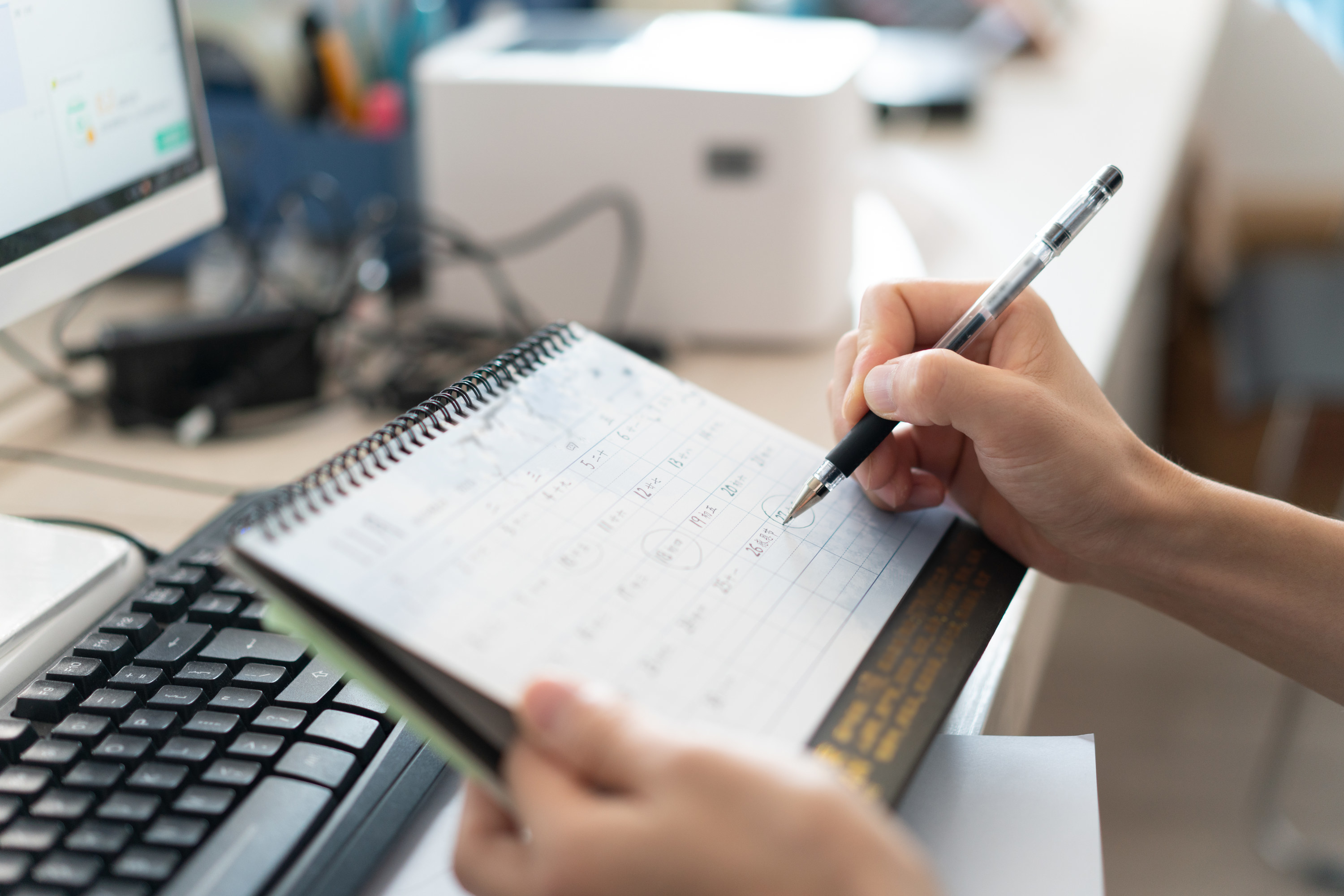 Person circling a date on their calendar