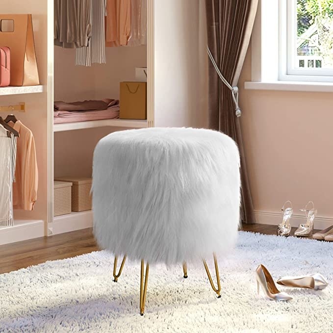 A fluffy stool sitting on a plush rug in a large closet