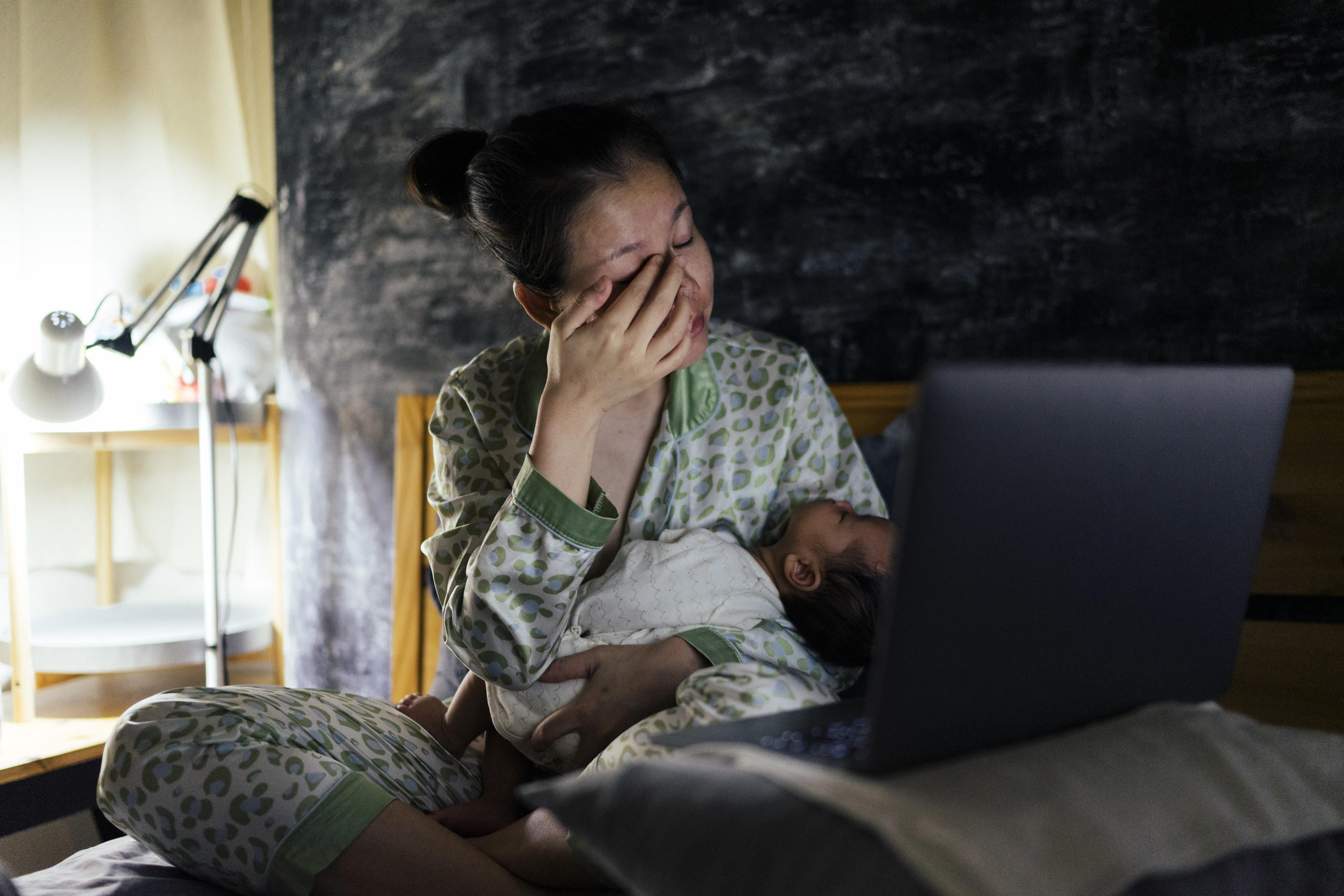 Tired mother with young baby