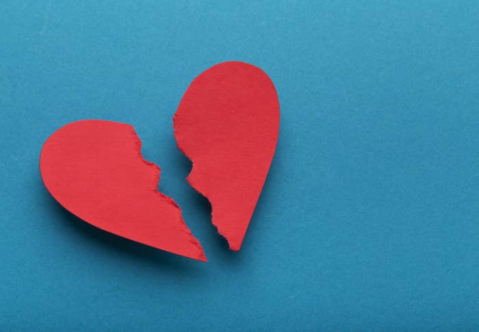 A stock image of a paper heart ripped in half