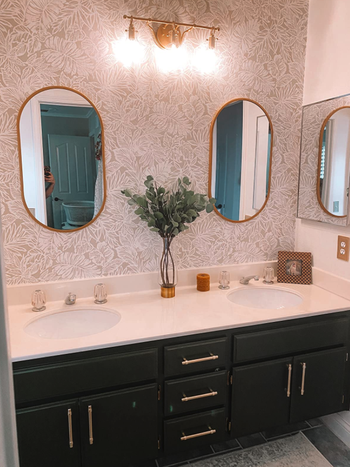 different reviewer's bathroom with black cabinets and gold pulls installed on drawers and cabinets