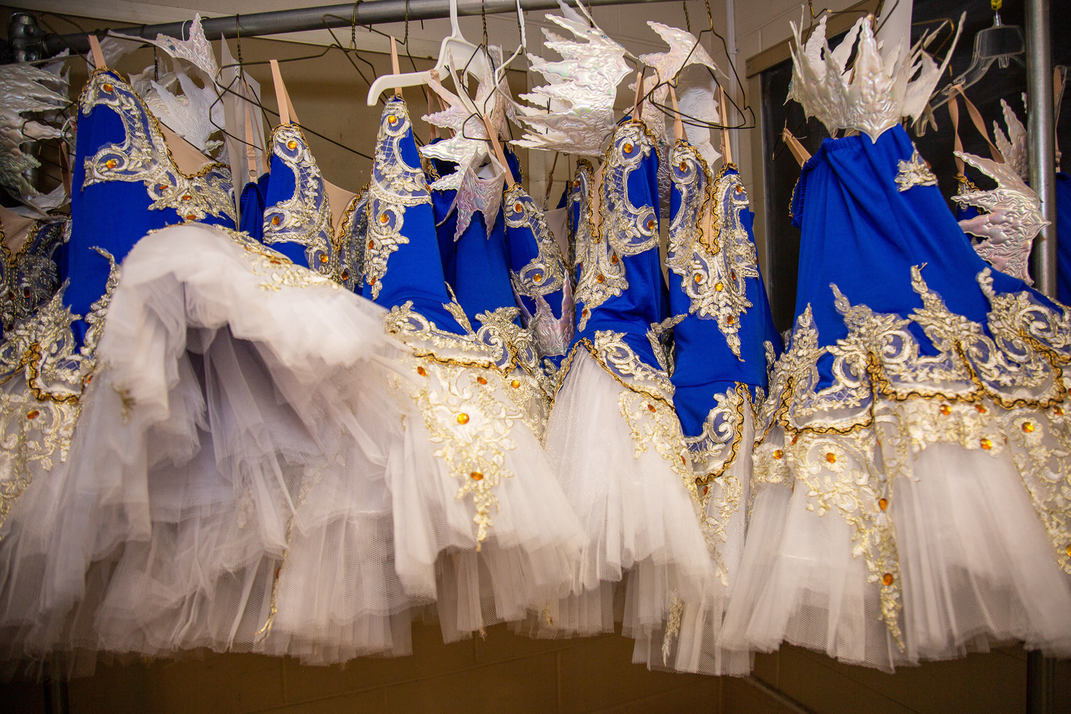 blue ballet costumes line up on hangers