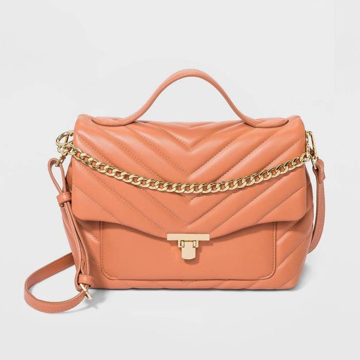 A coral orange quilted satchel bag