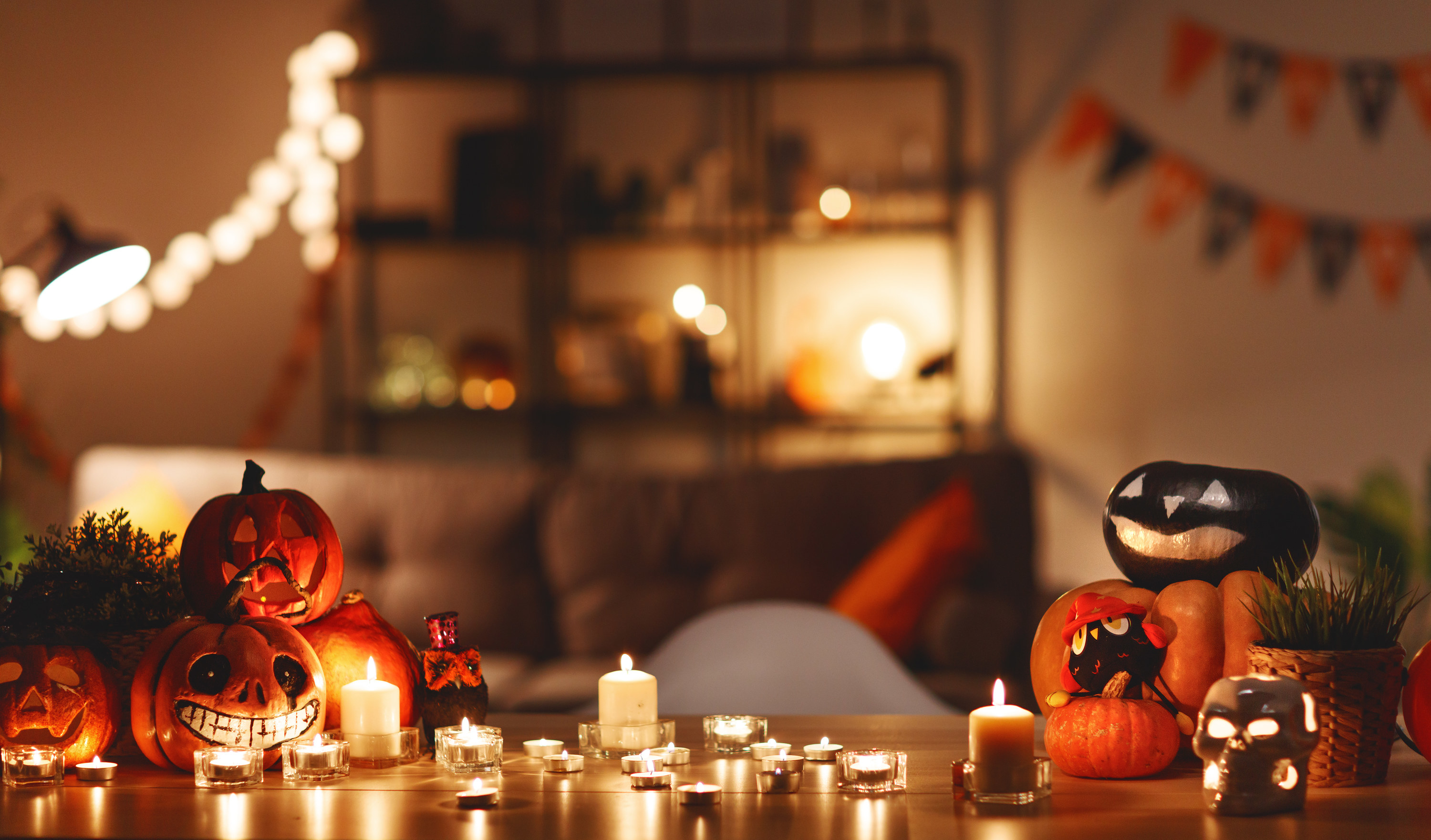 table with pumpkins and candles at a Halloween party