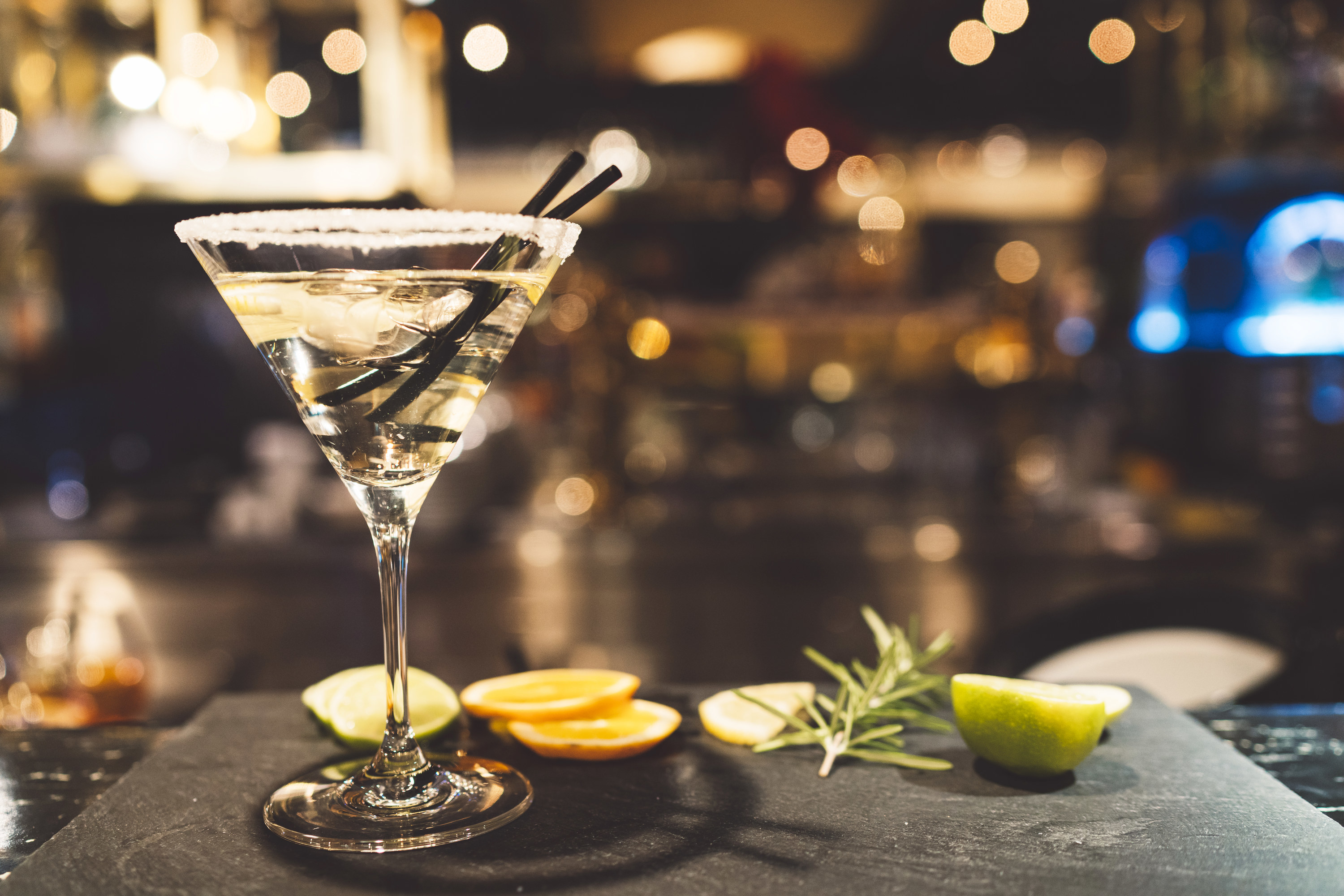 gin martini in a martini glass with garnishes