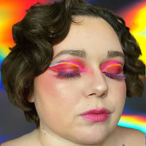 reviewer wearing the tinted hydrator along with colorful makeup
