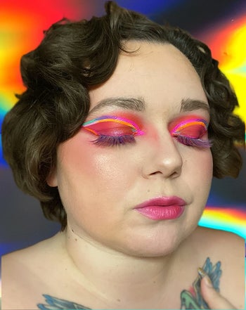 reviewer wearing the tinted hydrator along with colorful makeup
