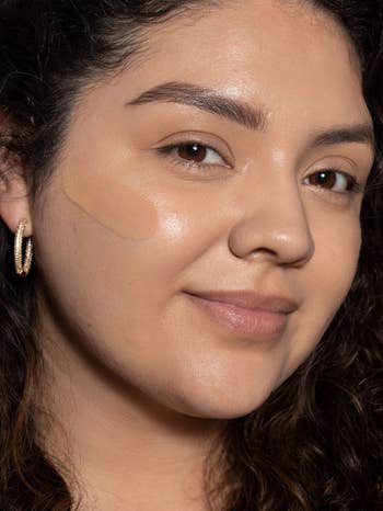 a model with a swatch of tint on their cheek