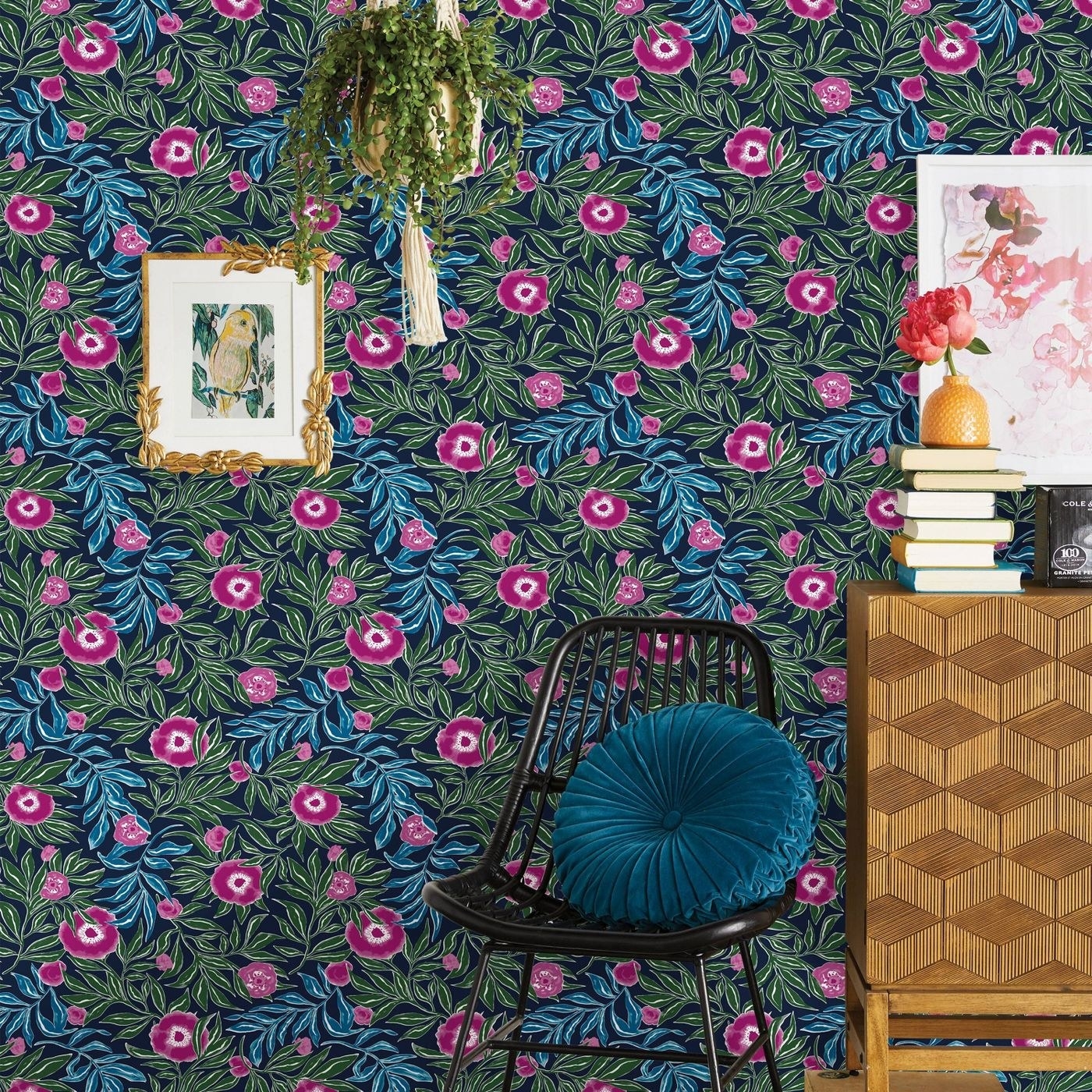 The dark blue, green, and magenta floral wallpaper on a wall
