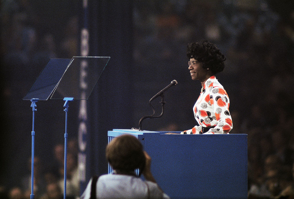 A Black woman speaking at a podium