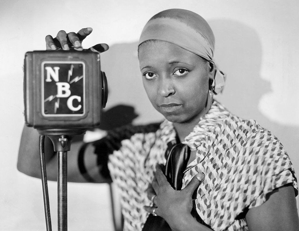 A Black woman with an NBC microphone