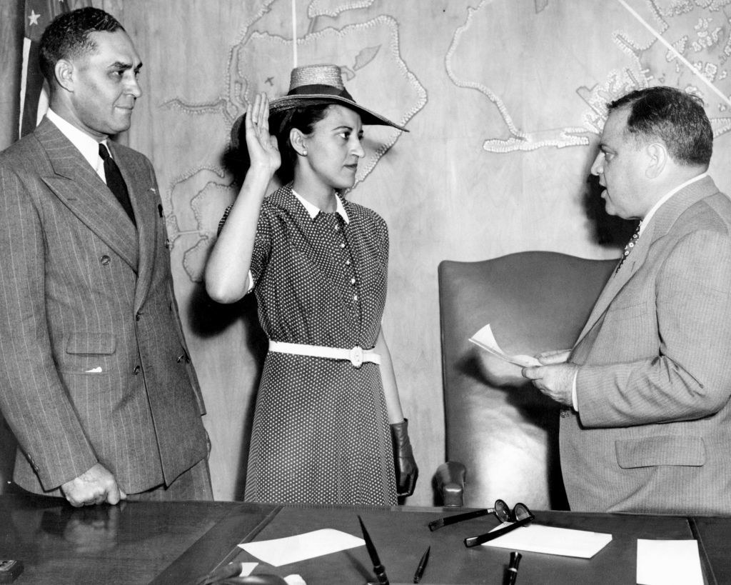 A Black woman being sworn in by a judge