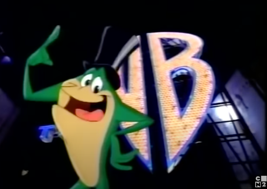 Michigan J. Frog standing in front of wb logo