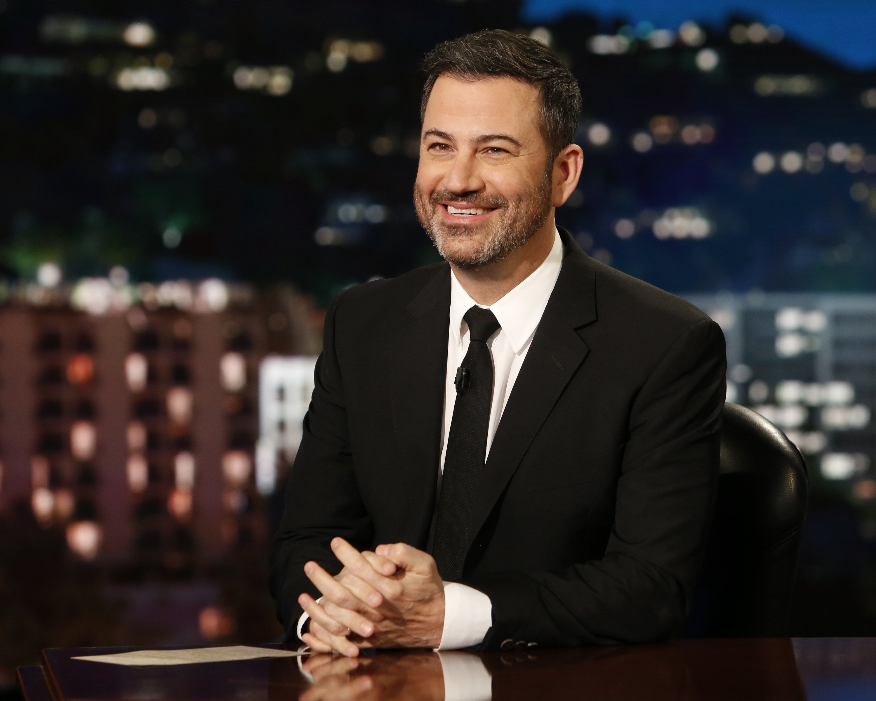 Kimmel smiles at his desk