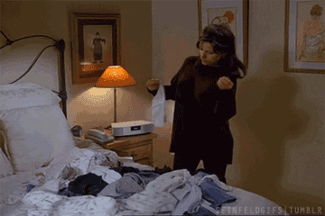 Elaine folding laundry on the bed