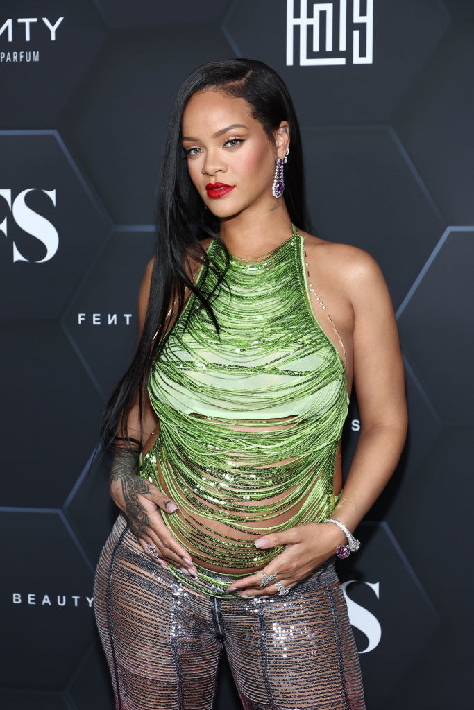 Rhianna rocking a fringe top that exposes her baby bump at a Fenty event