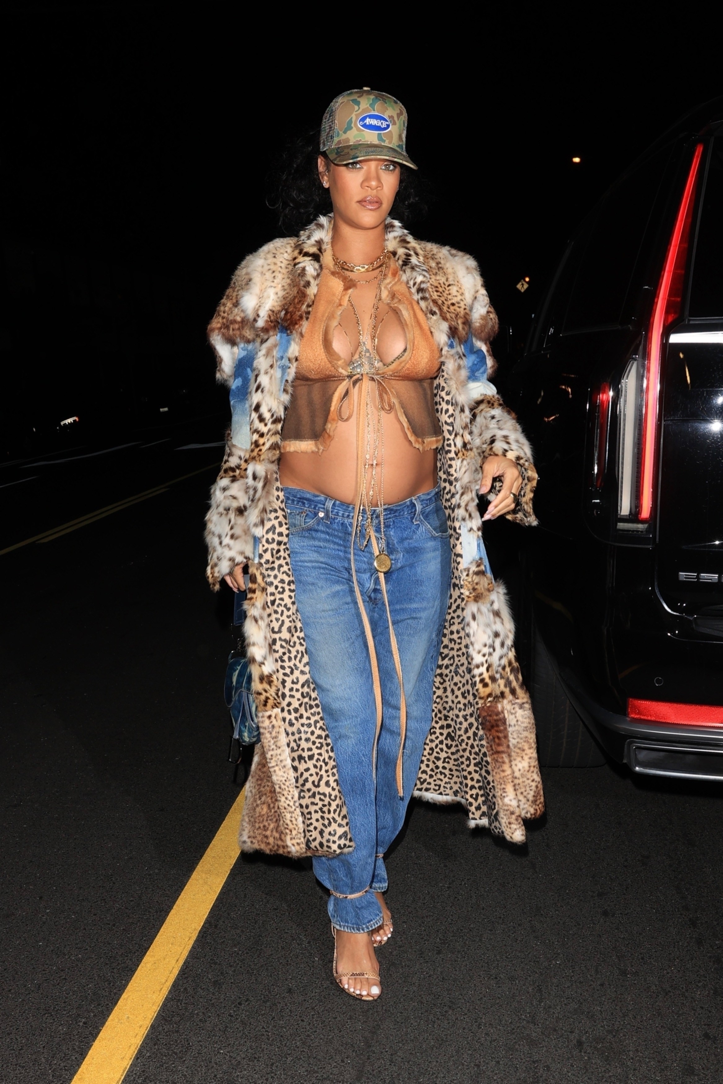 Rihanna spotted outside in jeans bikini top and fur coat