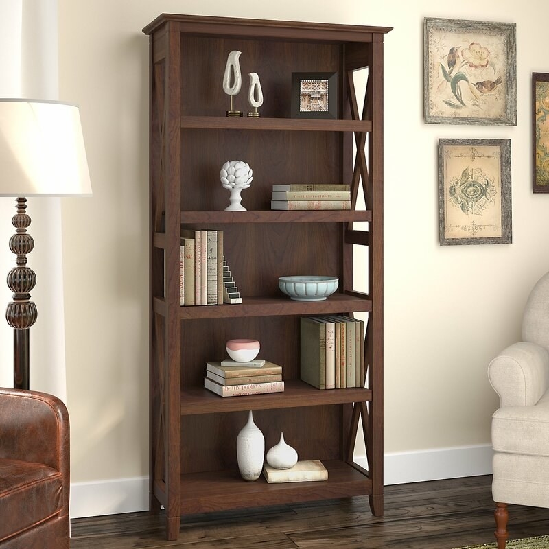 Brown bookcase filled with books and accessories
