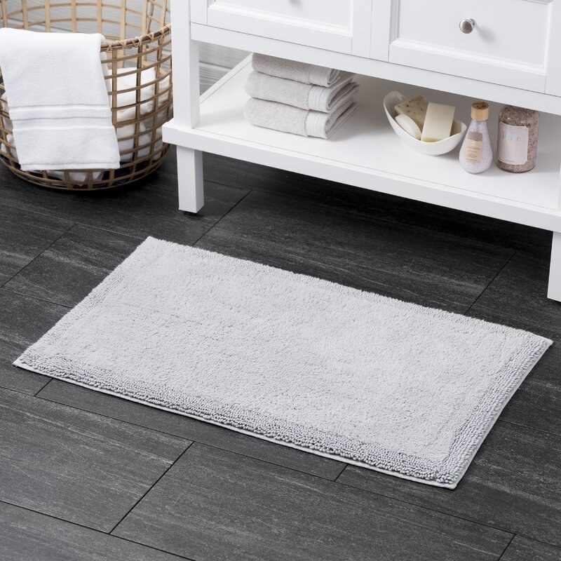 Gray bath mat on slate tile