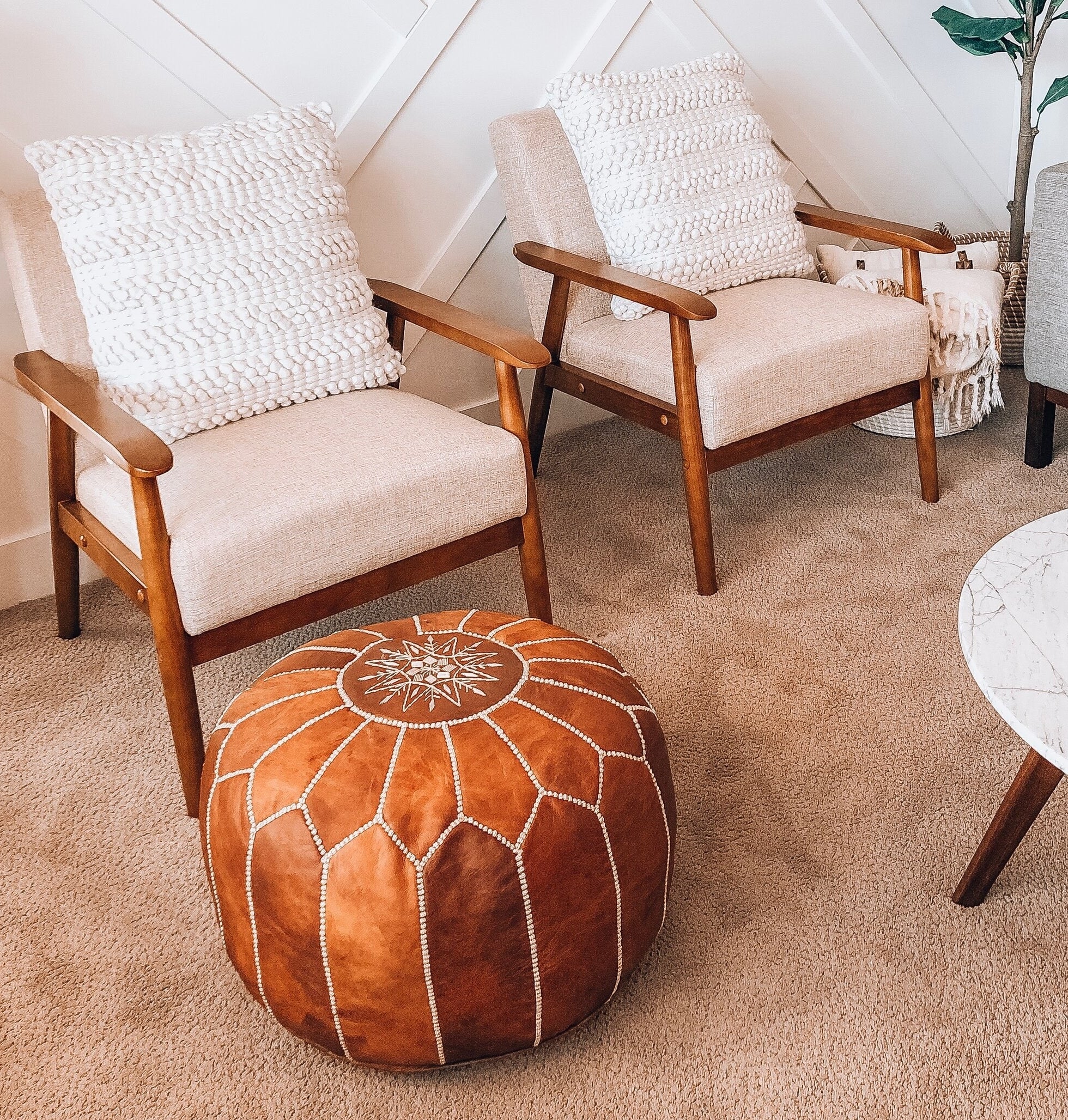 the brown leather stitched round ottoman