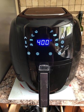 reviewer image of the black air fryer on a kitchen countertop