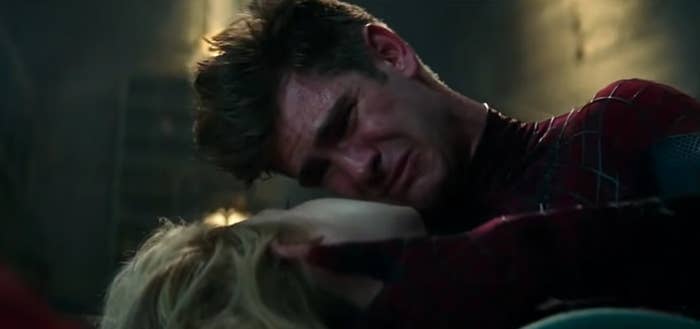 screenshot of spiderman holding gwen while crying