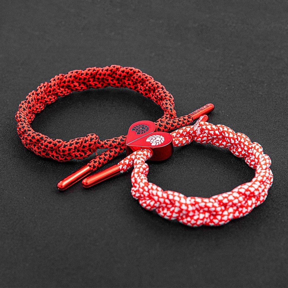 two red rastaclat bracelets that connect at the middle to form a heart