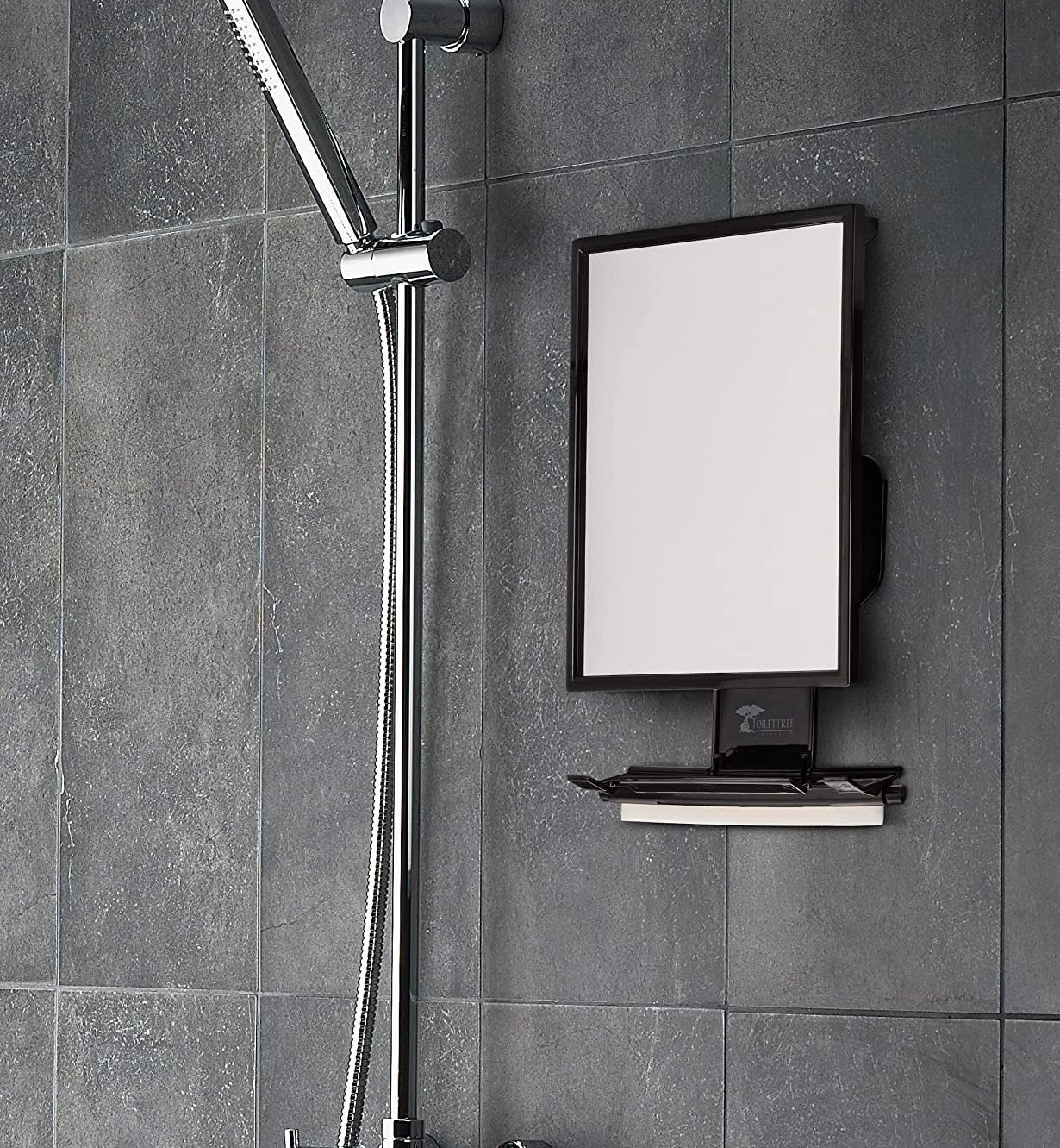 an adjustable anti fog mirror mounted on a tiled shower wall