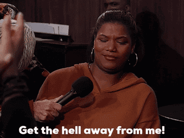 Queen Latifah as Khadijah James leans away from a microphone and says &quot;Get the hell away from me!&quot; in &quot;Living Single&quot;