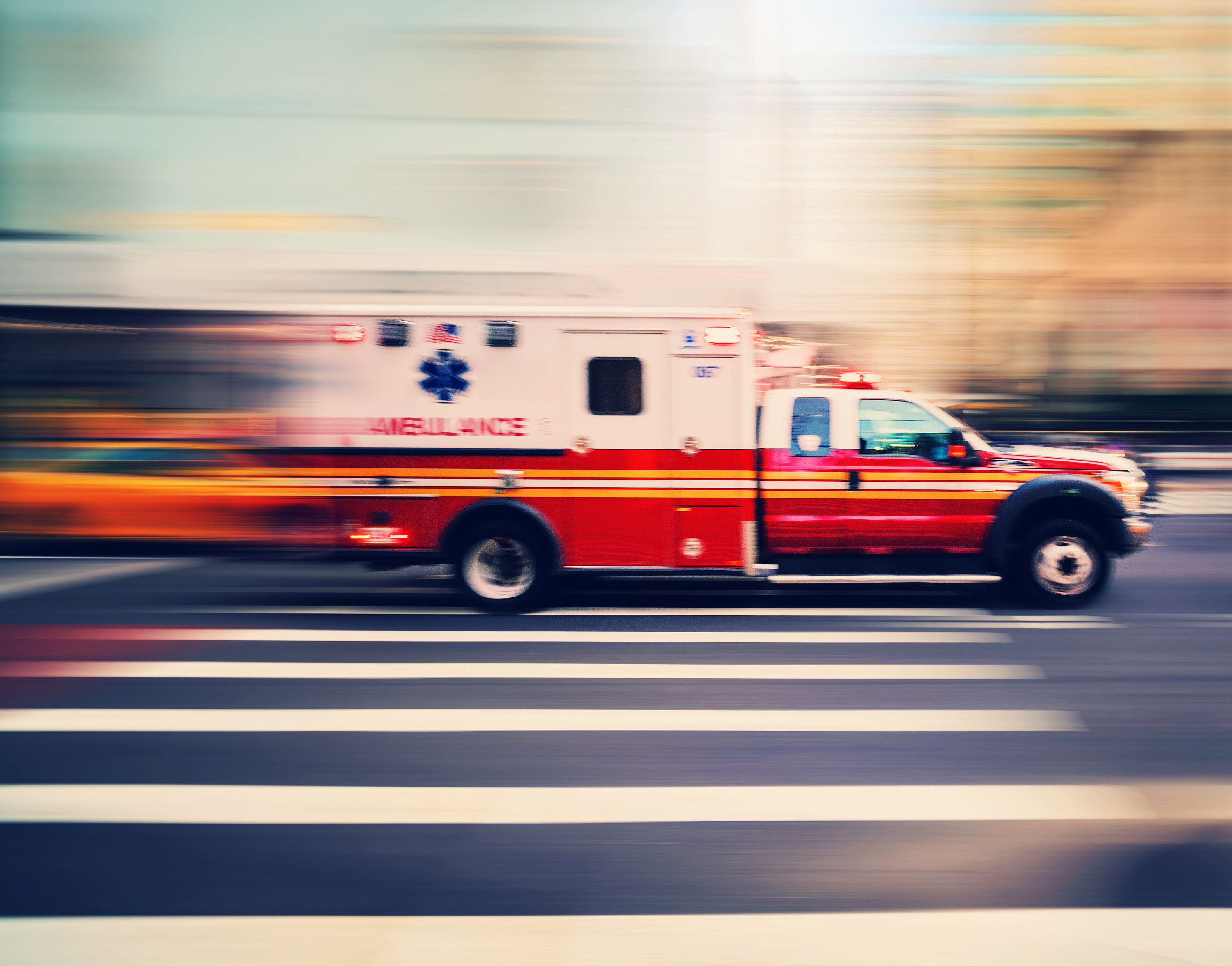 an ambulance driving down a street