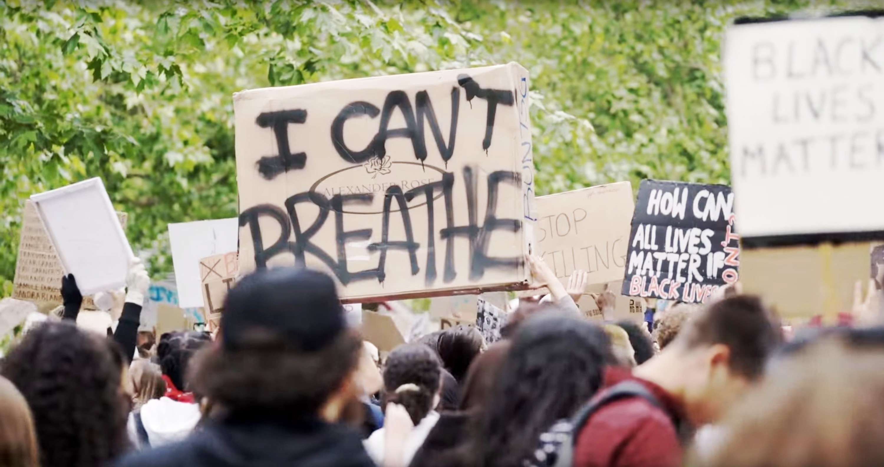 Protesters with a signs that read &quot;Black Lives Matter&quot; and &quot;I Can&#x27;t Breather&quot;