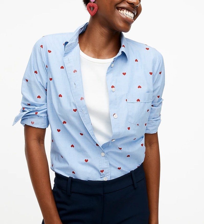 A model wearing a blue button-up with red heart printes