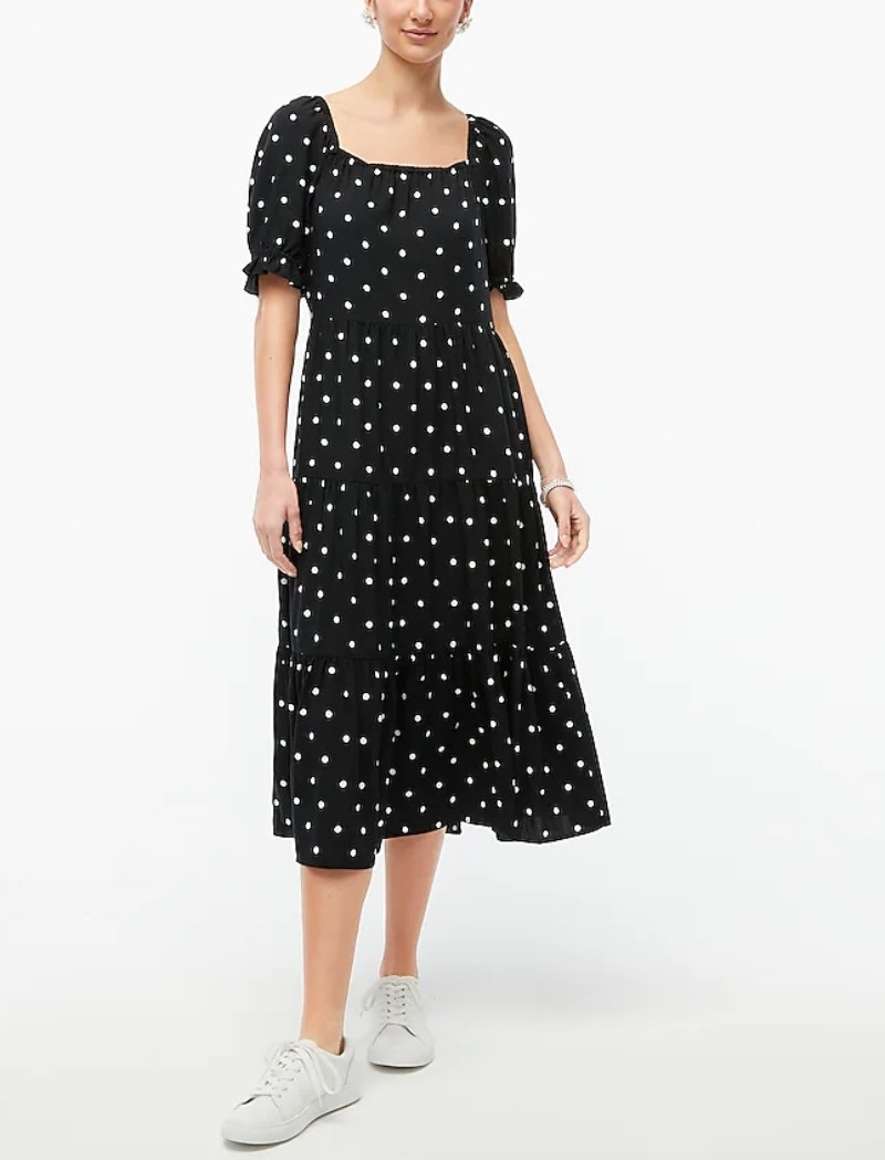 A model wearing a black/white polka dot puff sleeve midi dress