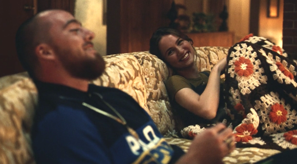 Fez and Lexi laughing as they sit on the couch