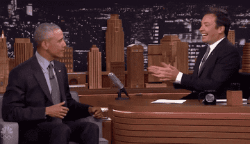 a gif of obama shrugging while jimmy fallon laughs