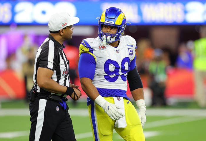 A member of the LA Rams talking to a referee on the field