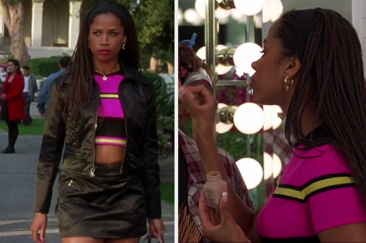 Dionne wears a bright pink striped sweater and a black satin skirt and jacket set