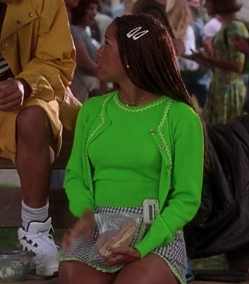 Dionne sits with Murray at lunch and wears a neon green cardigan and top with a gingham skirt