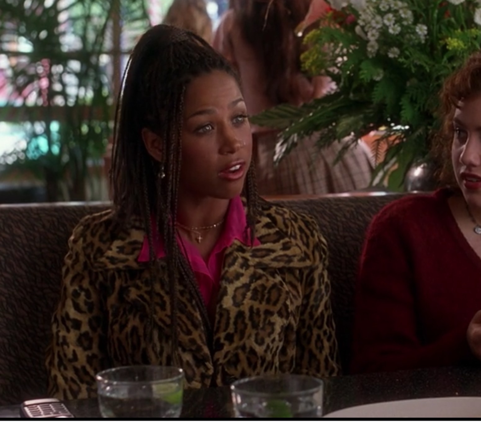 Dionne wears animal print while talking to Tai and Cher at a restaurant