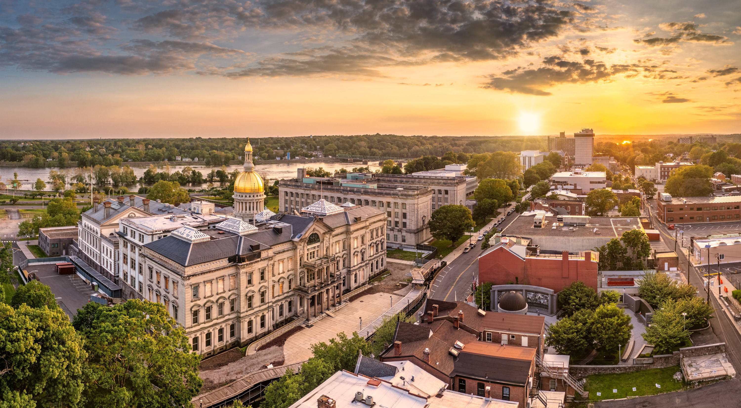 An aerial shot of Trenton, NJ at sunset with the capital building in full view