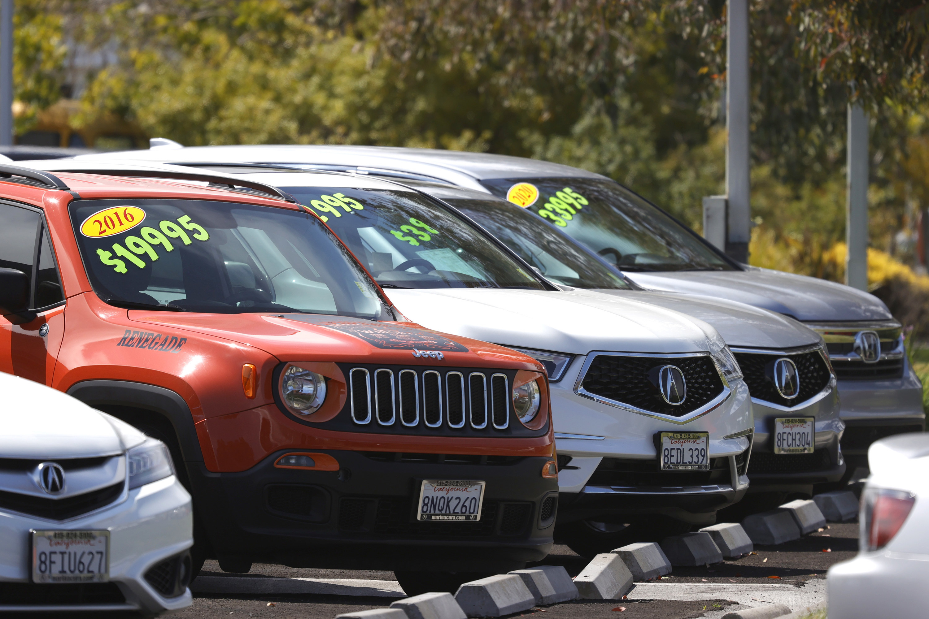 Used cars for sale with sticker prices on the windshields