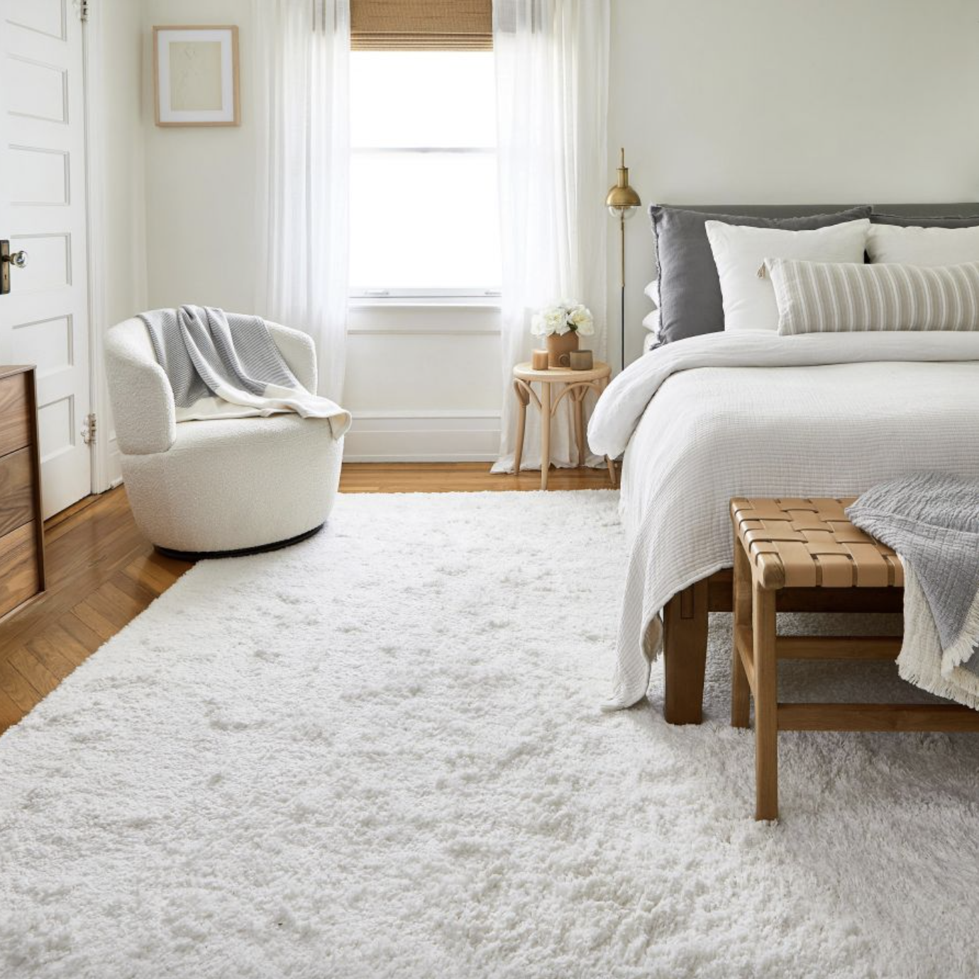a white shaggy rug in a bedroom