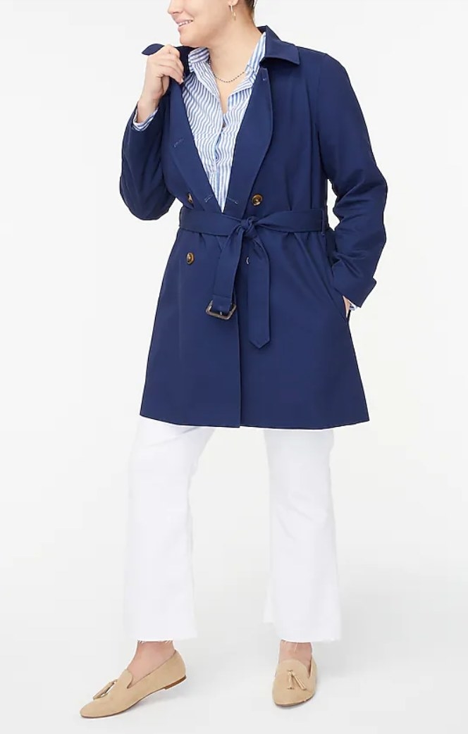 A model wearing a navy trenchcoat