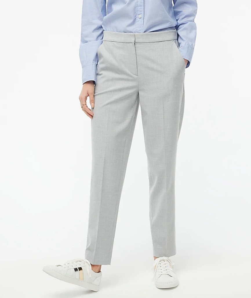 A model wearing a pair of grey suit pants