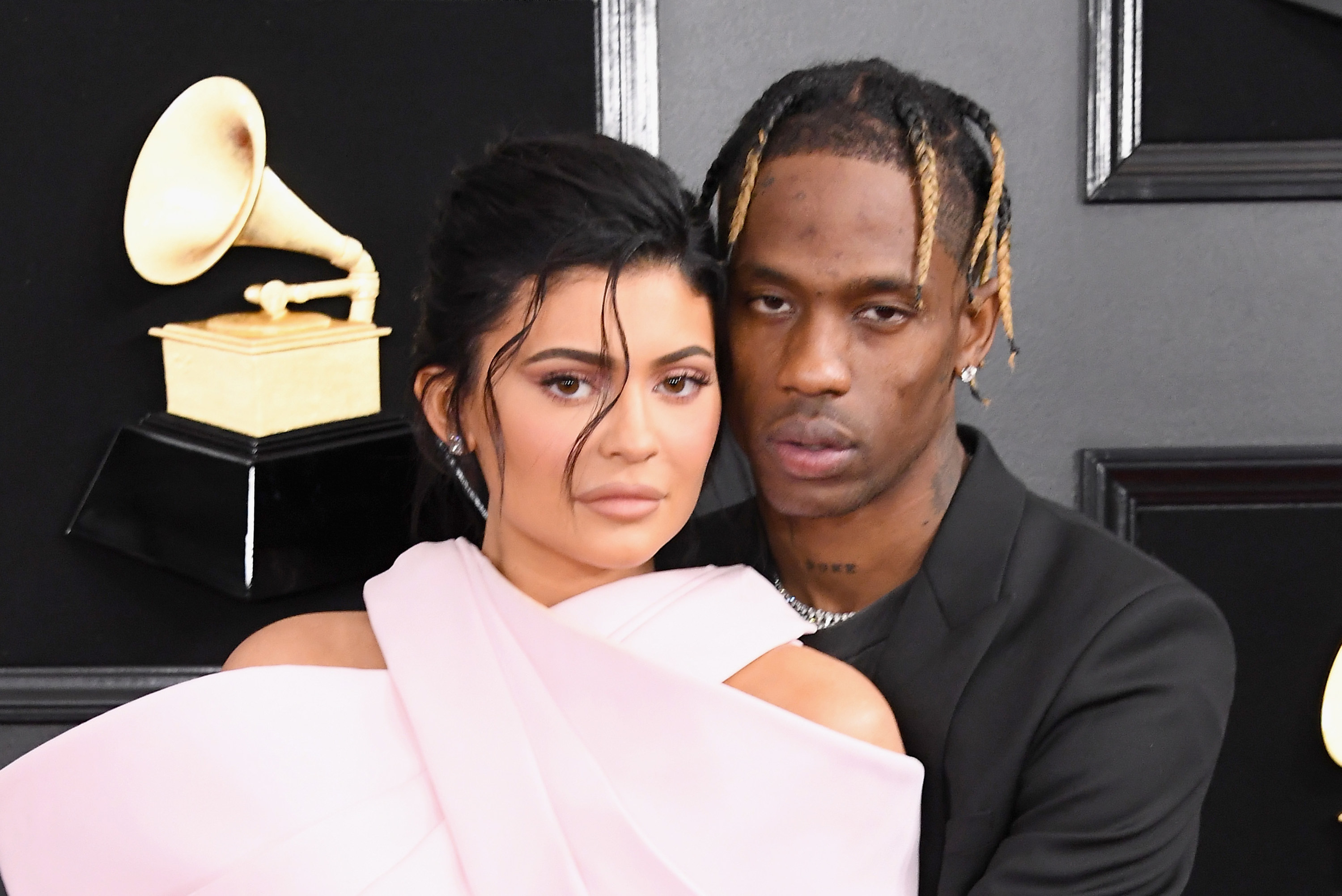 Kylie and Travis pose together at an event