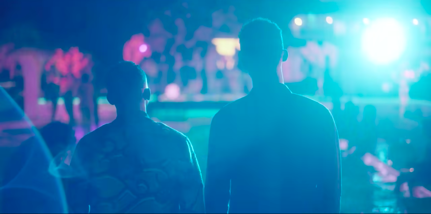 A silhouette of two people at a party