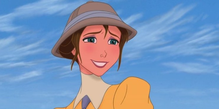 A close up of Jane as she wears a brightly colored gown and a safari hat