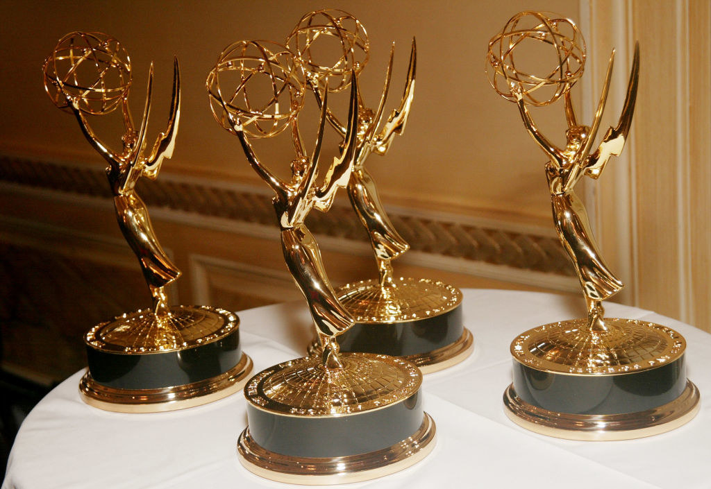 four golden angel statuettes sit on a table, waiting to be given out as awards