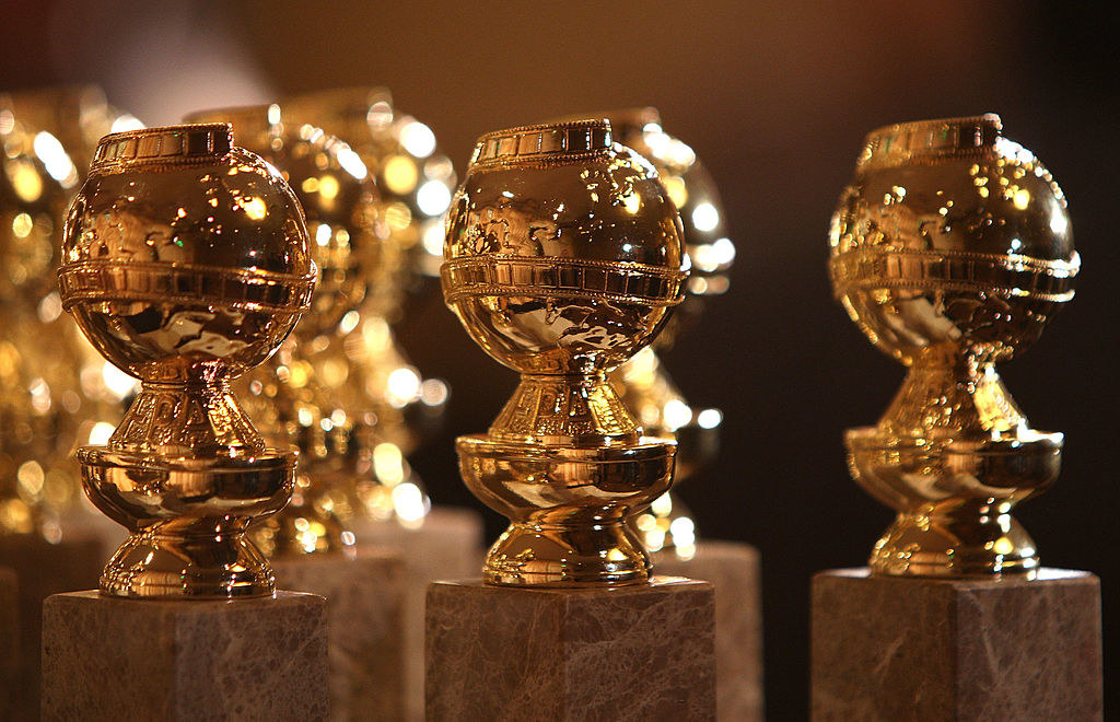 a trio of shiny trophies shaped like globes with film strips wrapped around them