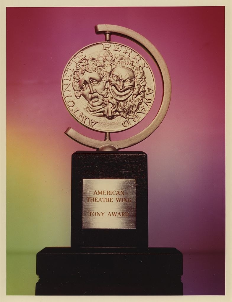 a trophy comprised of the classic happy/sad theatre symbol on a small pedestal